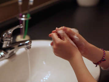 Child washing their hands