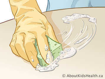 Bàn để rửa bàn tay mang găng có miếng cao-su bọt với xà-phòng