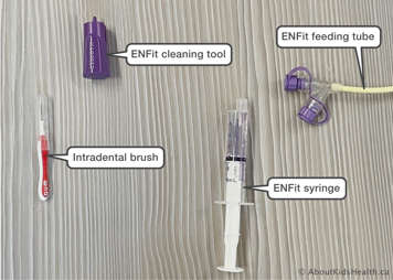 supplies including ENFit cleaning tool, intradental brush, ENFit syringe, ENFit feeding tube