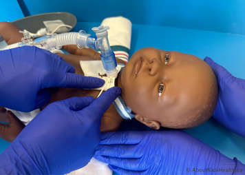 Gauze being inserted around new tracheostomy tube