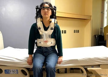 Sitting up on a bed while wearing a halo vest device