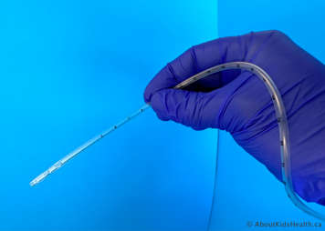 Person holding the suction catheter four to six inches from the end