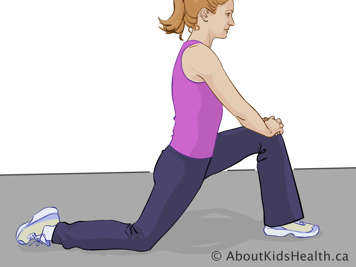 Woman on one knee with leg stretched along the floor behind her and the other foot flat on the floor in front of her