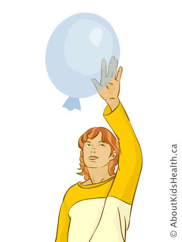 Girl hitting a balloon in the air
