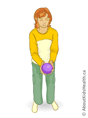 Girl holding a ball out in front of her with both hands