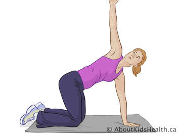 Woman kneeling on mat with one arm on the mat and one arm stretched upward above her head
