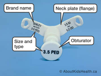 Brand name, size and type, neck plate and obturator on a tracheostomy tube