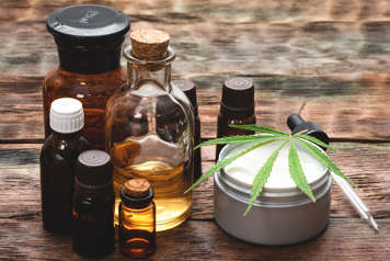 Bottles and jars of cannabis products and cannabis leaf
