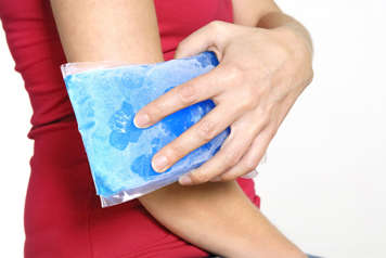 Person applying freezer pack to elbow