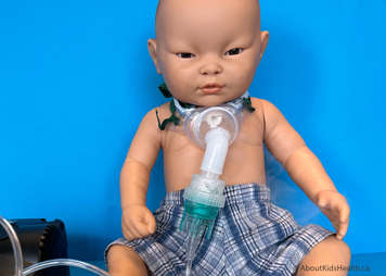 Child with tracheostomy mask set up showing mist