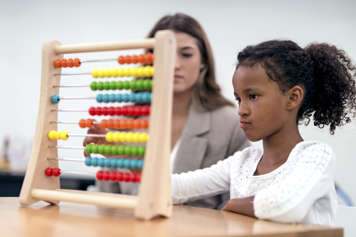 Testing child using coloured beads