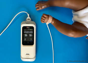 Oximeter attached to child's foot showing an accurate reading