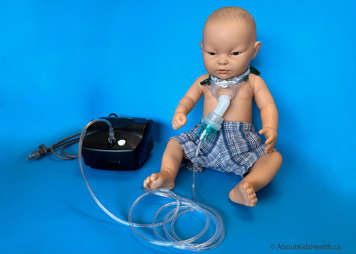 Child with tracheostomy mask set up showing tubing attached to the nebulizer