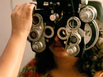 An optometrist checks a patients binocular vision