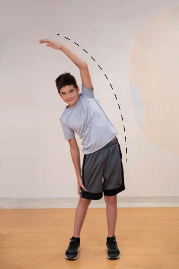boy bending to the left with right arm over head