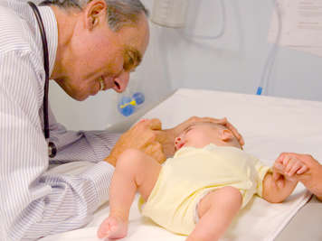 Doctor looking at baby