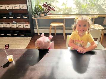 young girl with tracheostomy tube sitting in a classroom