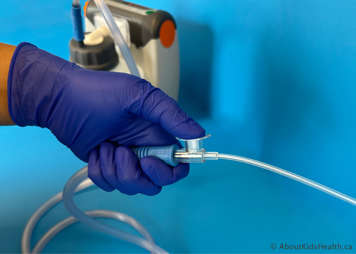 Suction is applied by holding the thumb over the suction control port