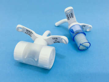 Heat and moisture exchangers attached to tracheostomy tubes