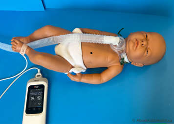 Child with a tracheostomy tube lying comfortably